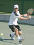 Jesse Brauer prepares to return a shot against Coe.