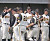 The Gusties celebrate a Mother's Day sweep against Simpson College.