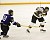 Jay Phillips shoots the puck in front of a Tommie.