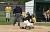 Shea Roehrkasse tags a sliding Alex Fokken out at home plate.