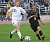 Matt Broin runs with the ball with a Nebraska Wesleyan player trailing.