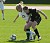 First-year Alison Dittmer battles St. Olaf senior forward Kelsey Watt for the ball.