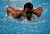 A Gustavus swimmer in the midst of a butterfly stroke