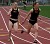 Kim Swanson hands off to Maggie Stolp in the 4x100-meter relay.