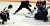 Patrick Dynan works to control the puck on his knees in front of the St. Thomas net. (Photo: Ryan Coleman, d3sports)