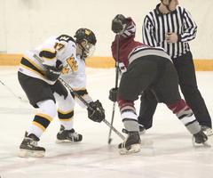 Mike Hosfield wins a face off against the Pipers.