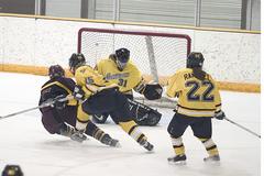 Goaltender Kara Meyer stops Concordia forward Hannah Impola from point blank range.