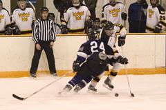 Gustavus' Ben Ollila skates past Kevin Rollwagen.