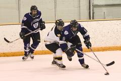 A Gustavus defender attempts to slow down Saint Thomas' Andrew Edwards.