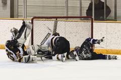 Goalie Erik Kraska hits the ice after a collision Friday night.