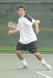 Danny Suchy returns a forehand in his doubles match.