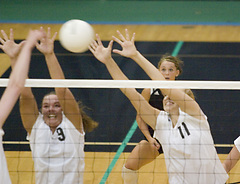 Jami Moseng (left) and Andrea Kron (right) extend for the block