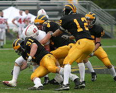 The Gustie defense wraps up Johnnie running back Corey Weber.
