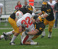 Defensive tackle Nick David teams with Jared Chapman to take down Johnnie running back Mike Lofboom.