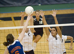 The Gustie front row goes up for a block.