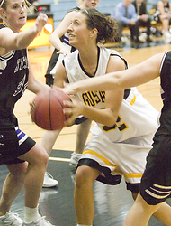 Bri Monahan fights through a pair of Wildcat defenders.