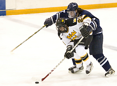 Senior Steve Dusich is hounded from behind by a Lawrence defender.