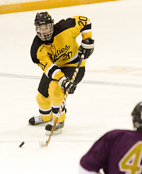 Junior Jon Keseley moves toward center ice with the puck.