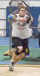 Junior Andy Klaers spins en route to a win in the weight throw.