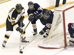 Sophomore Sami Idris looks to make a pass from behind the net.