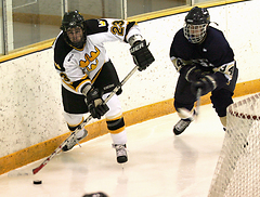 Senior Steve Dusich plays the puck behind the net.