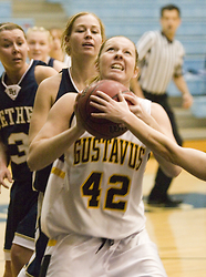 Sophomore Vicky Peterson fights with a pair of Bethel defenders for control of the ball.