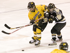 Andrea Peterson and an Ole fight for possession of the puck.
