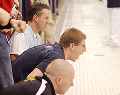 Brian Amundson (center) emphatically cheers on the 800 freestyle relay team.