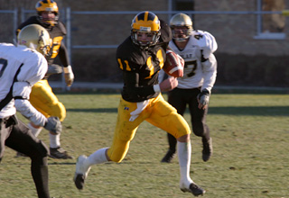 Senior wide receiver Tim Nesvig runs for a first down in the second half against St. Olaf.