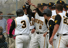 Senior Andy Schmidt is congratulated after homering during game one.