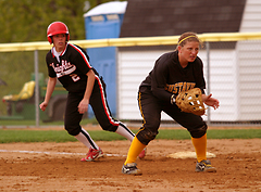 Senior Audrey Lenoch gets sets to field a bunt as a Martin Luther player leads off first base.
