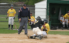 Shea Roehrkasse tags a sliding Alex Fokken out at home plate.
