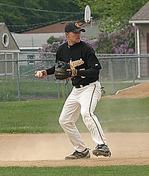 Aaron Madson checks the runner at second base before throwing to first base.