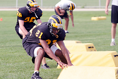 Senior defensive back Brian Evans pushes off the bag during a defensive drill.