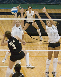 Jessica Plemel (left) and Becca Thompson go up for the block as Rachelle Jakobs looks on from the back row.
