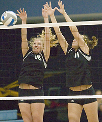 Jessica Plemel (left) and Danielle Gimmestad (right) try to block the ball.