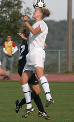Liz Petersen heads the ball for Gustavus.