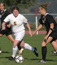 Shannon Quealy watches the ball as a Wildcat brings it up field.