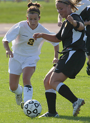 Kirsten Thulien looks to take the ball away from a Wildcat.