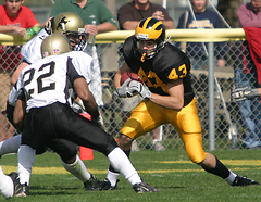 Chad Arlt makes a move on a St. Olaf defender