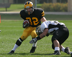Senior defensive back Wade Vrieze makes a move against a St. Olaf player following an interception.