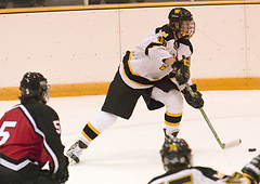 John Arundel passes the puck in the offensive zone.