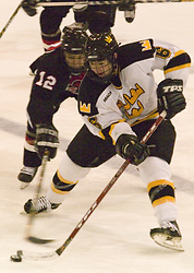 Cody Mosbeck tries to keep the puck away from a Falcon.