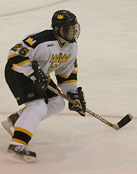 Niko Suoraniemi maintains his focus on the player with the puck.