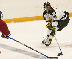 John Arundel attempts to keep the puck from a Johnnie.