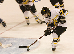 Christine Wicker tries to get a handle on a puck inside the crease.
