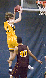 Trevor Wittwer rips down the rebound as Cobber junior Erik Johnson looks on.