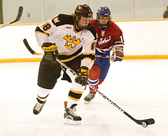 John Arundel carries the puck out of the Gustavus zone.