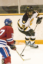 Sami Idris controls the puck along the boards.
