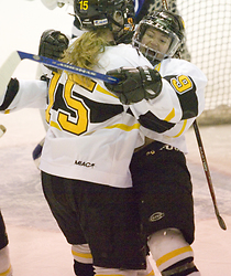 Kelly Crandall (#9) celebrates with Marge Dorer (#15) after scoring the first goal of the game.